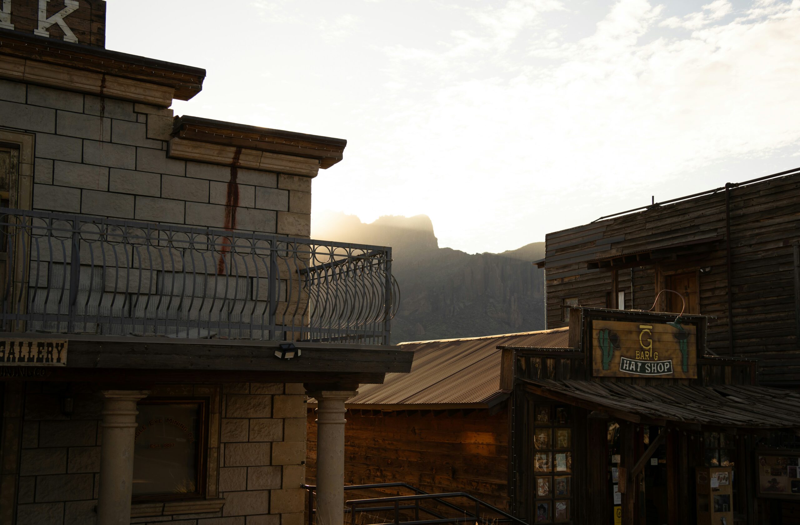 a building with a balcony and mountains in the background