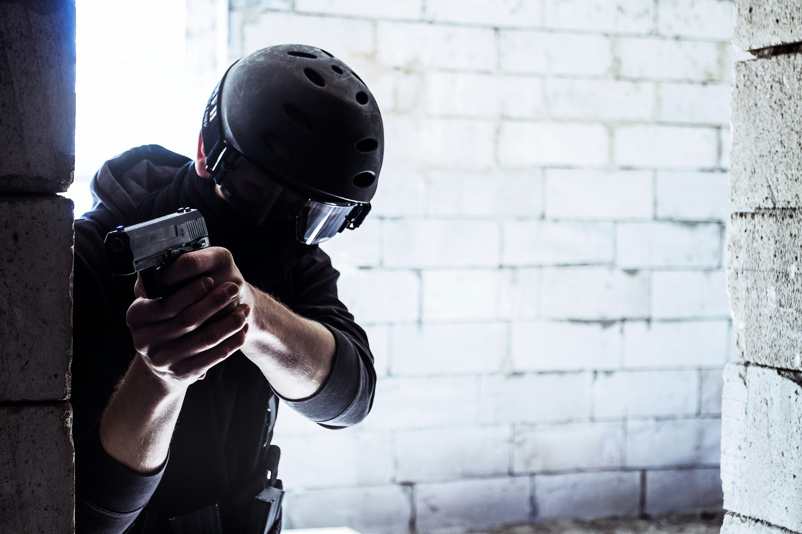 man in black helmet holding black smartphone